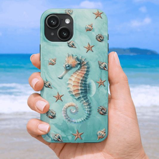 iPhone 17 phone case with seahorse design held by a hand on a beach background