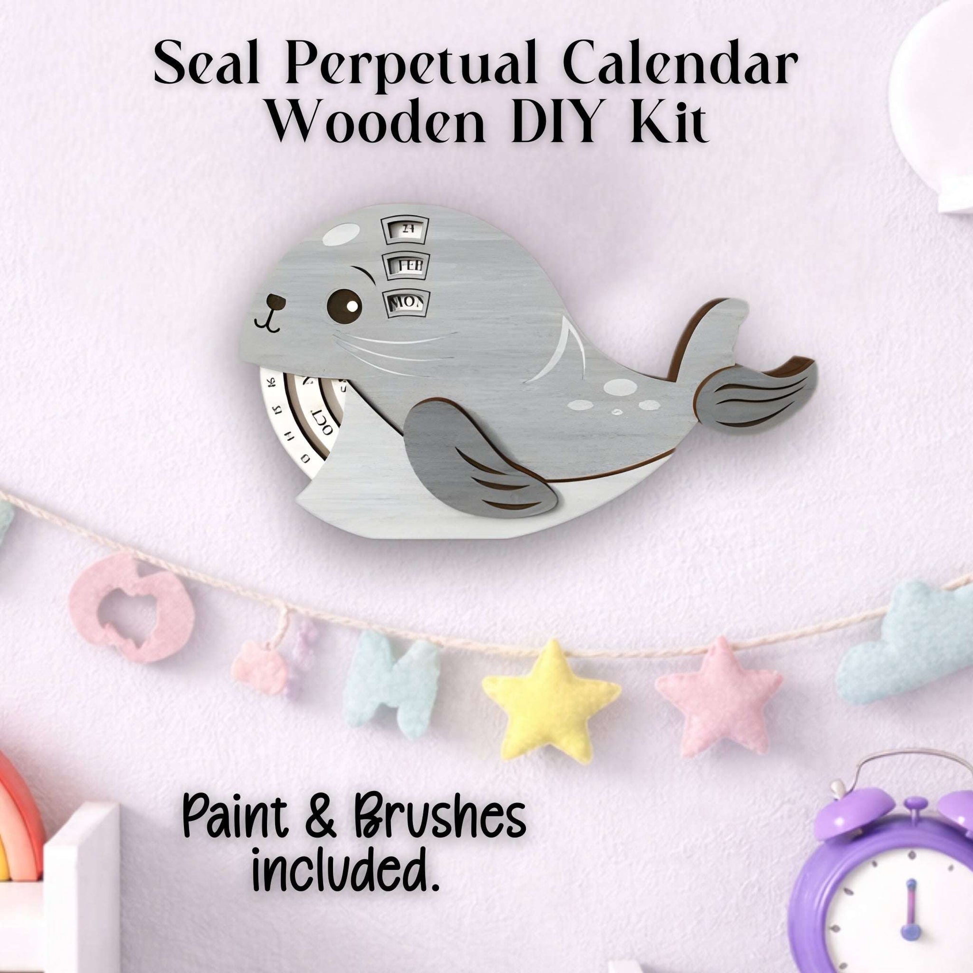 Wooden DIY kit for a seal perpetual calendar with paint and brushes included, shown completed.
