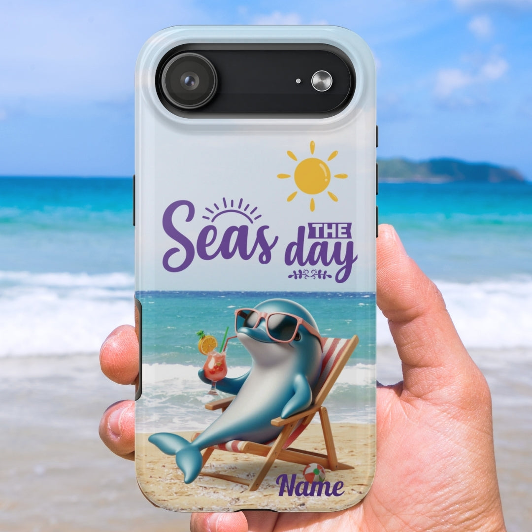 Phone case with a dolphin lounging on the beach with a cocktail and the text 'Seas the Day' and can be customized. 