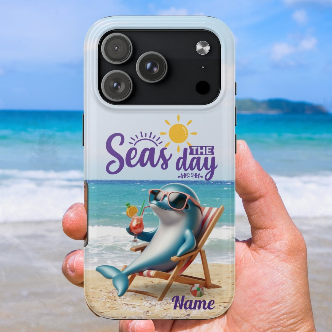 Phone case with a dolphin lounging on the beach with a cocktail and the text 'Seas the Day' and can be customized. 