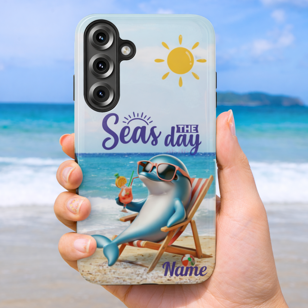 Phone case with a dolphin lounging on the beach with a cocktail and the text 'Seas the Day' and can be customized. 