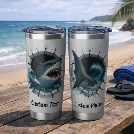 Two tumblers with shark design on a beach setting