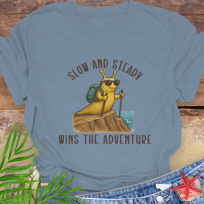 Blue t-shirt with a snail graphic and text 'Slow and Steady Wins the Adventure'.