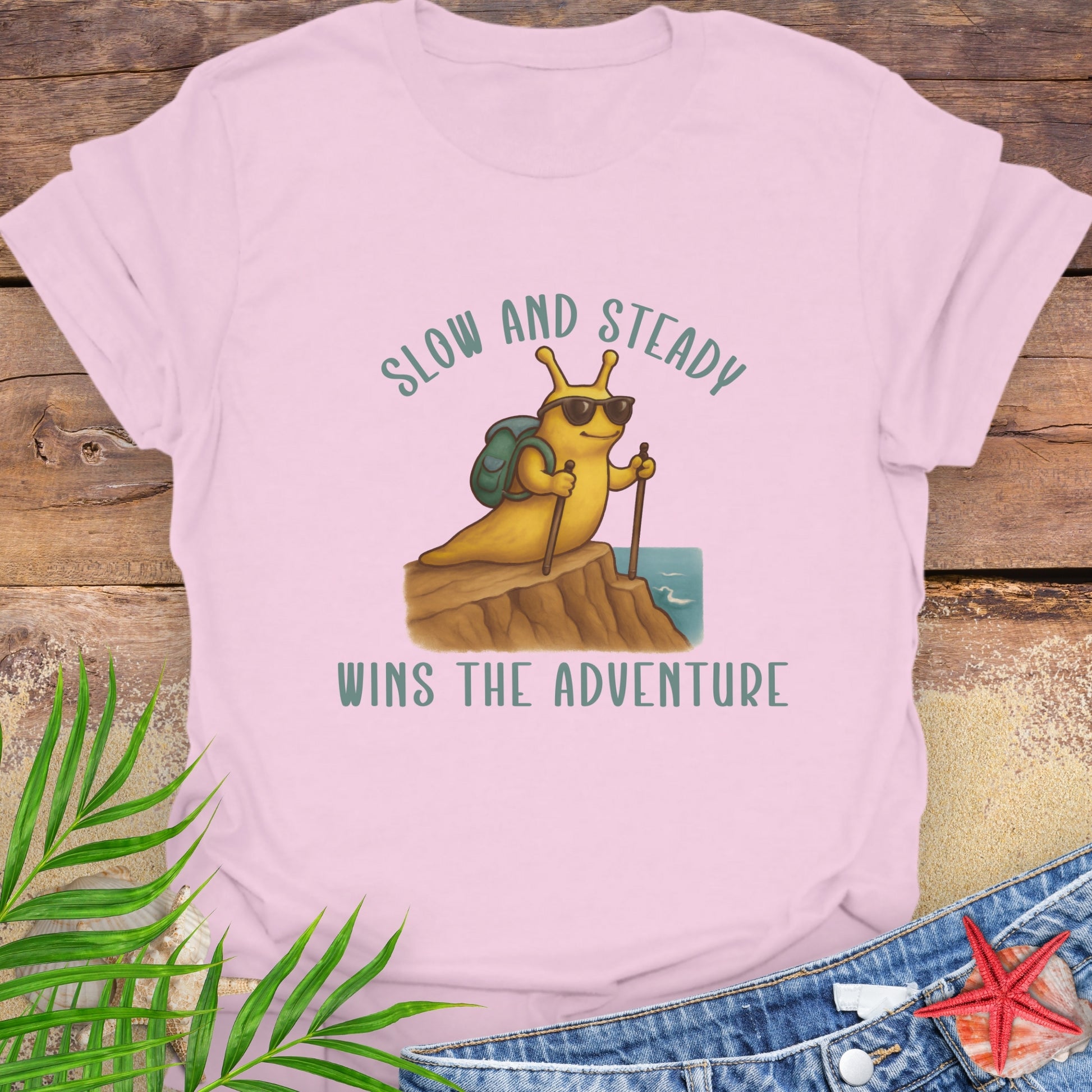 Pink t-shirt with a cartoon character and 'Slow and Steady Wins the Adventure'.