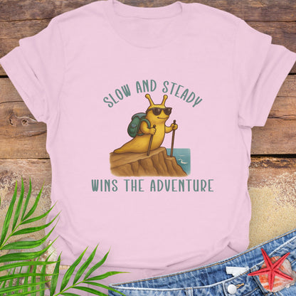 Pink t-shirt with a cartoon character and 'Slow and Steady Wins the Adventure'.
