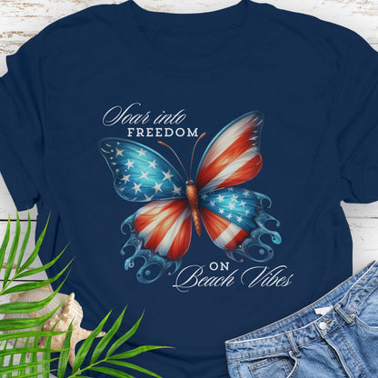 Navy American flag butterfly T-shirt with “Soaring into Freedom” slogan, made of 100% ring-spun cotton, classic fit with crew neckline, perfect for patriotic holidays.