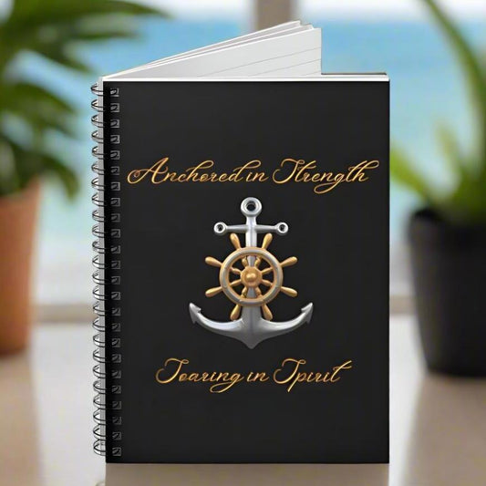 Black notebook with an anchor cursive text Anchored in Strength Soaring in Spirit