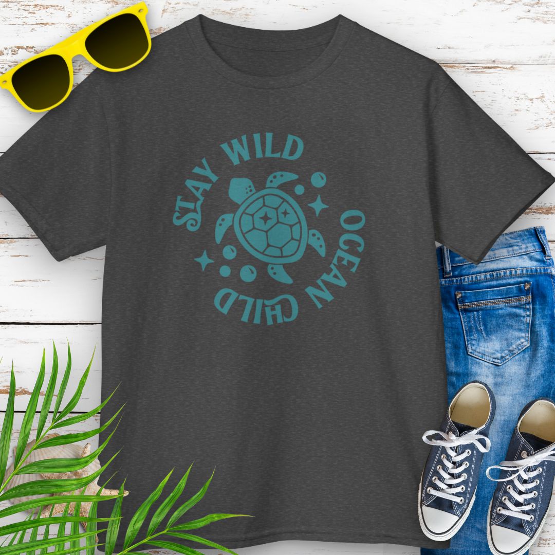 Dark heather kids ocean-themed T-shirt with sea turtle design and coastal vibes with phrase Stay Wild Ocean Child around sea turtle.