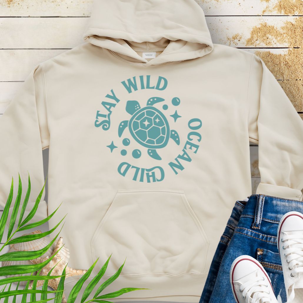 Sand sea turtle lover hoodie with ocean-inspired Stay Wild Ocean Child phrase around a sea turtle.