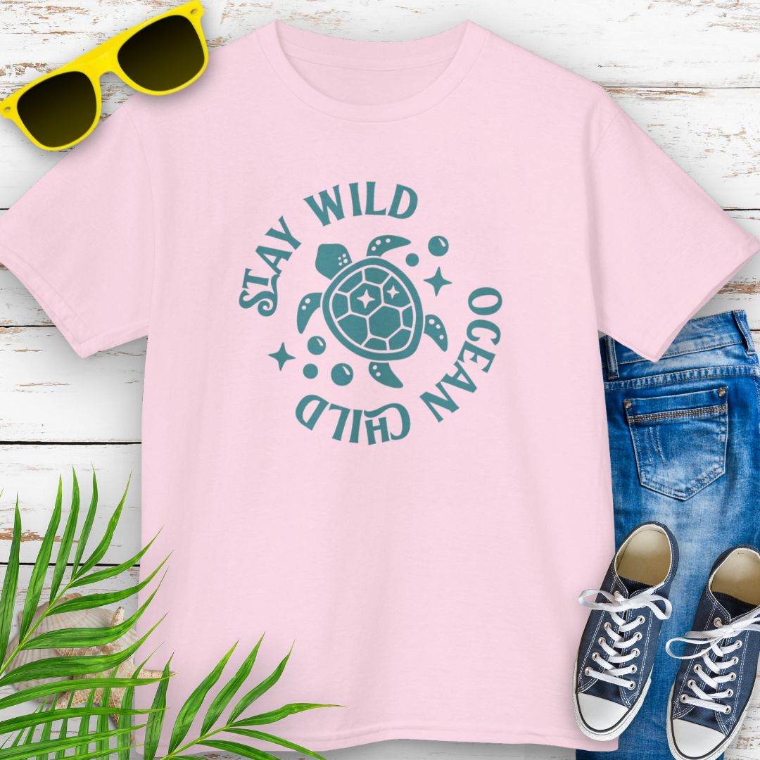 Pink kids ocean-themed T-shirt with sea turtle design and coastal vibes with phrase Stay Wild Ocean Child around sea turtle.