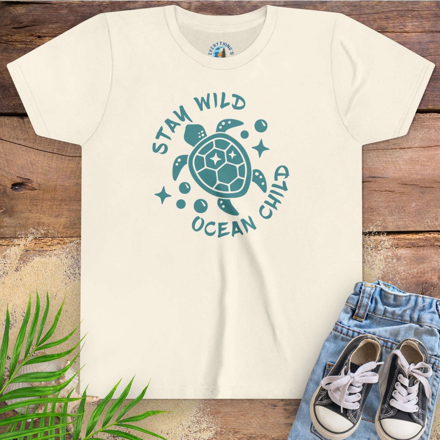 Beige t-shirt with sea turtle graphic and text stay wild ocean child.