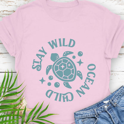 Pink Stay Wild Ocean Child Sea Turtle T-Shirt featuring a sea turtle with phrase around the turtle - a beachy, free-spirited vibe for sea lovers.