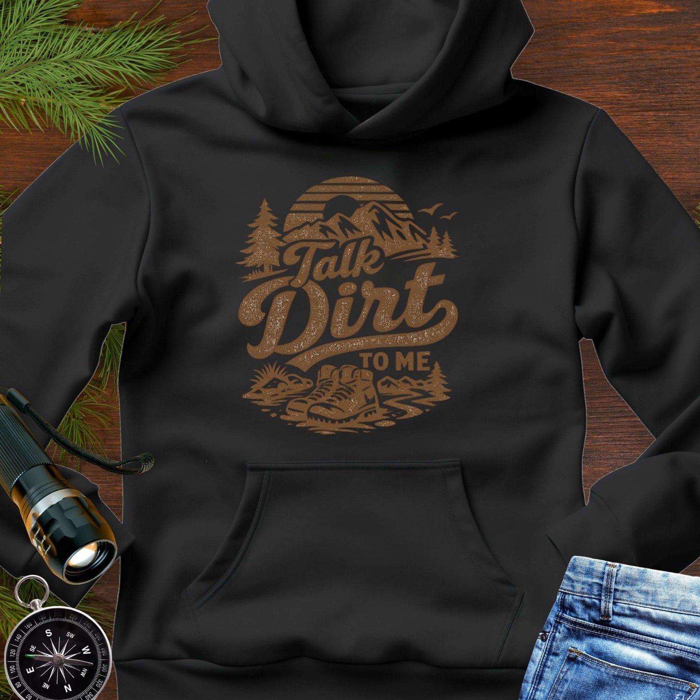 Black hoodie with “Talk Dirt To Me” retro mountain and hiking boots graphic, outdoor adventure pullover sweatshirt.