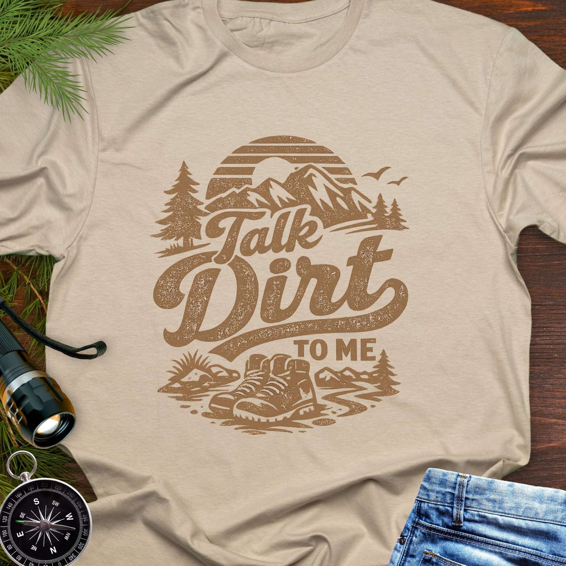 Beige t-shirt with 'Talk Dirt to Me' graphic design with rugged mountain trail graphic—perfect for hiking, camping, and off-road lovers.