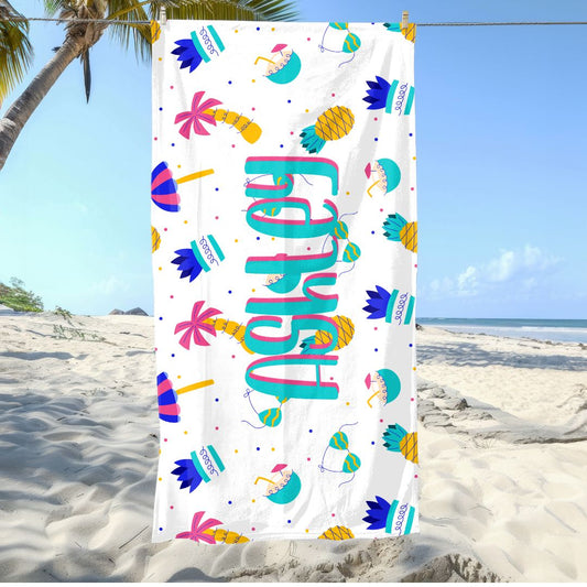 Colorful beach towel with pineapples, umbrellas, bikini, plants, palm trees, and personalized name.