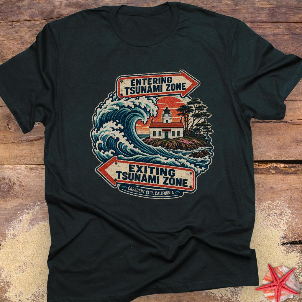 A black Crescent City California tsunami zone T-shirt design featuring a crashing ocean wave, coastal lighthouse, and vintage entering and exiting tsunami zone signs.