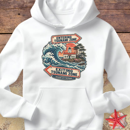A white Crescent City California hoodie design featuring a crashing ocean wave, coastal lighthouse, and vintage entering and exiting tsunami zone signs.