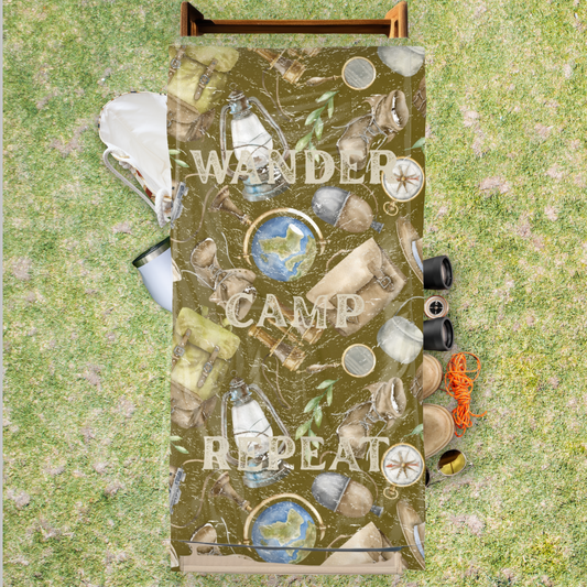 Olive green adventure-themed beach towel with camping elements and the phrase “Wander Camp Repeat”.