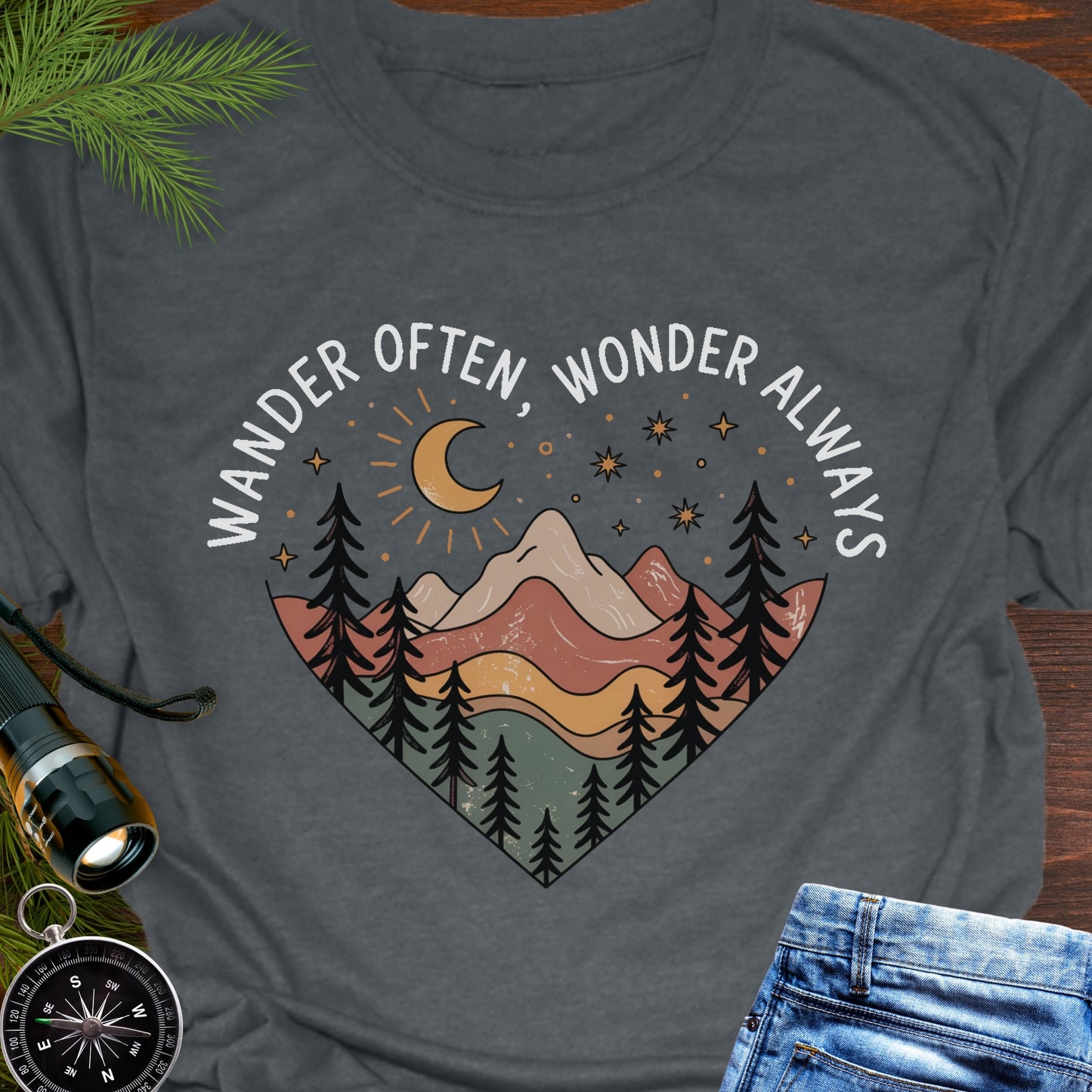 Dark Heather Gray  Unisex t-shirt with mountain and trees in a heart shape and the phrase "Wander Often, Wonder Always".