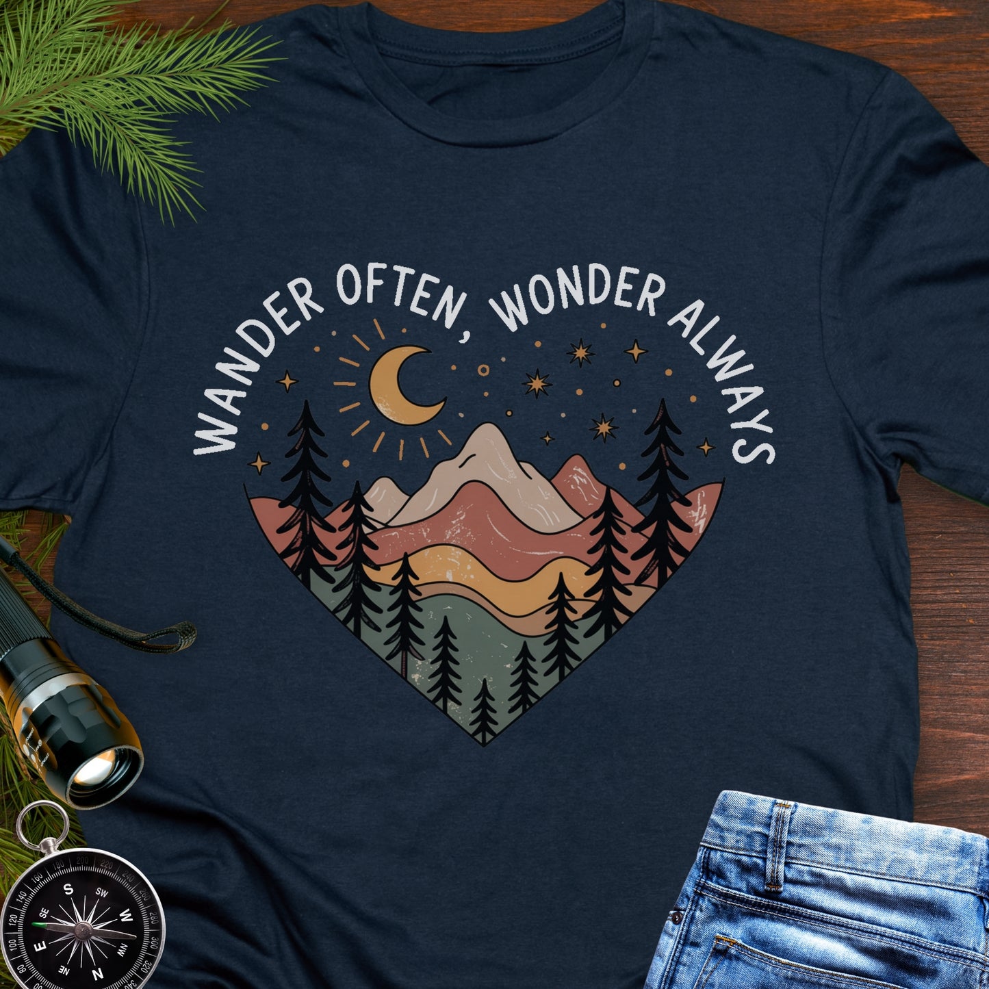 Navy Blue  Unisex t-shirt with mountain and trees in a heart shape and the phrase "Wander Often, Wonder Always".