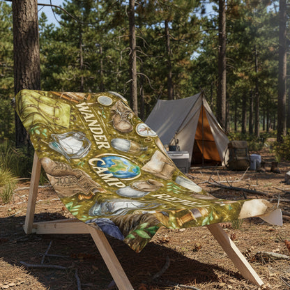 Beach towel with camp-themed design on a wooden chair at a campsite.