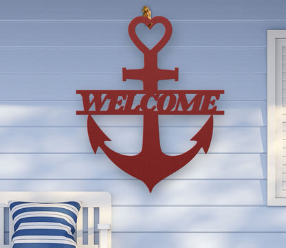 Red metal wall art shaped like an anchor with a heart at the top and the word “Welcome” cut out in the center; made of powder-coated steel.
