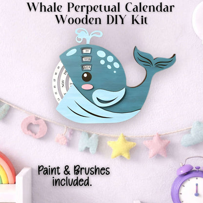 Whale-shaped perpetual calendar wooden DIY kit with paint and brushes included shown completed.