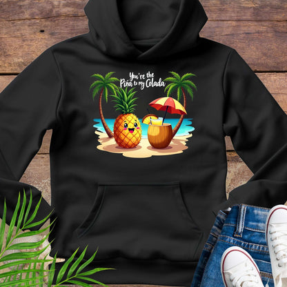 Black Hoodie with a pineapple and a coconut pina colada on a beach between two palm trees with the text You're the Pina to my Colada.