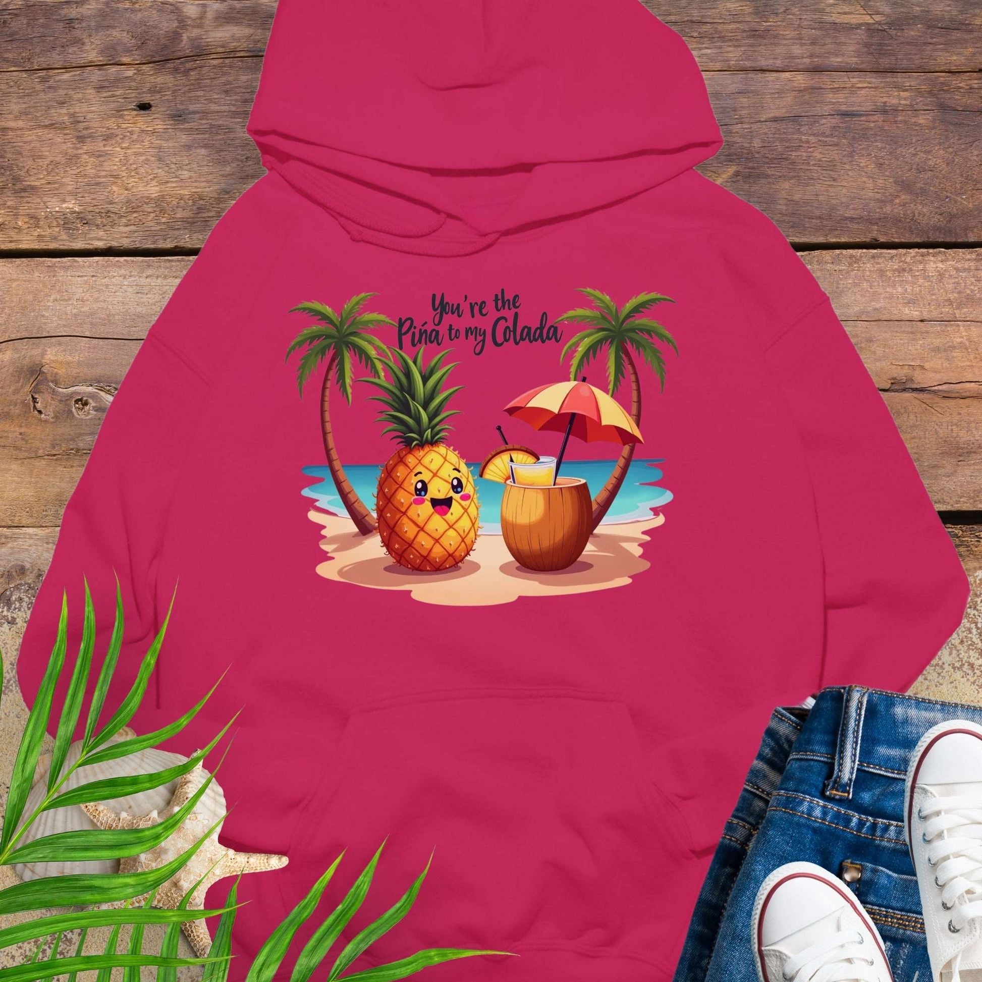 Hot Pink Hoodie with a pineapple and a coconut pina colada on a beach between two palm trees with the text You're the Pina to my Colada.
