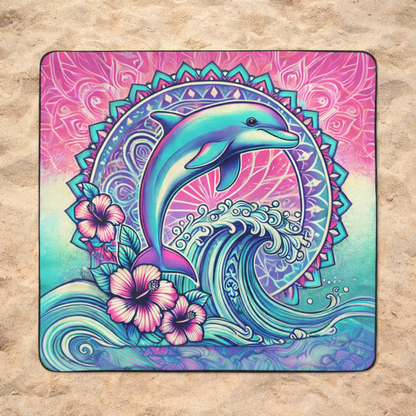 Colorful outdoor beach blanket with a dolphin coming out of waves and floral design.